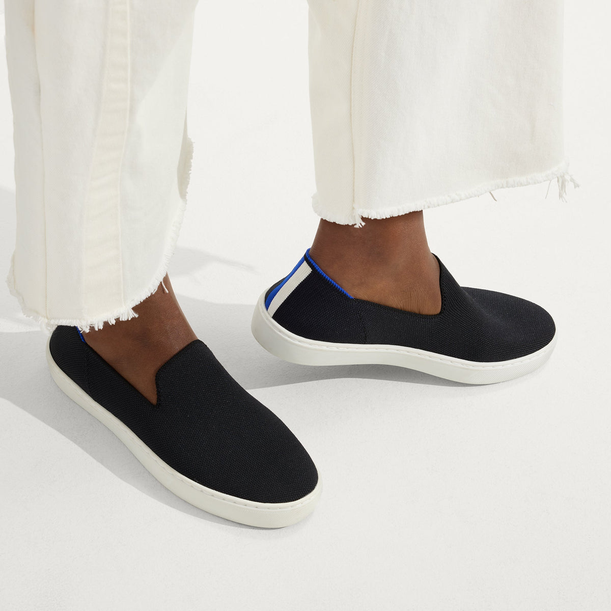 hover | The Original Slip On Sneaker in Black Solid shown on-model at an angle.
