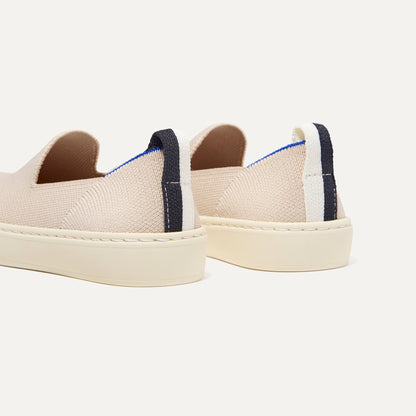 Close up of the heel of The Kids Sneaker in Sand, with shimmery gold pull tab.