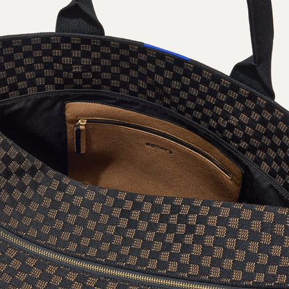 The Weekender in Night Song shown with a close up view of the interior zipper pocket in the magnetic side compartment.