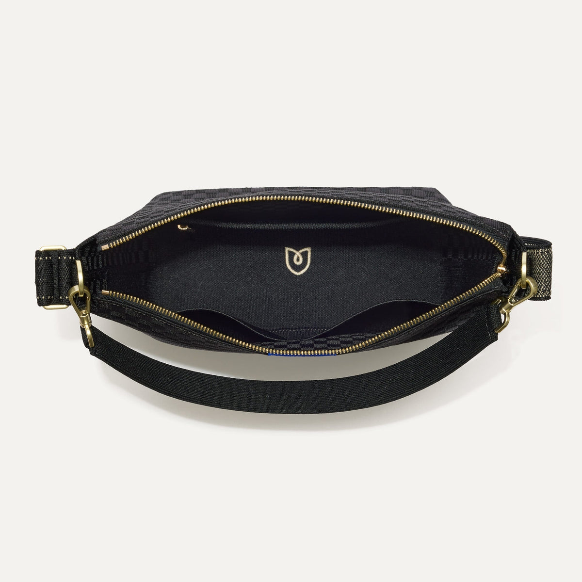 The Mini Zip Bucket in Black Sand shown from the top down, with zipper open and interior exposed.