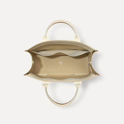 The Classic Tote in Buttercream, shown from above, with the interior exposed.