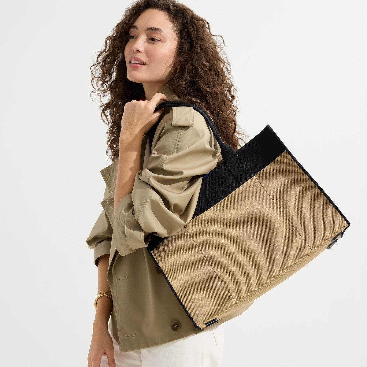 hover | The Classic Tote in Tiramisu, worn over the shoulder by a model, shown from the side.