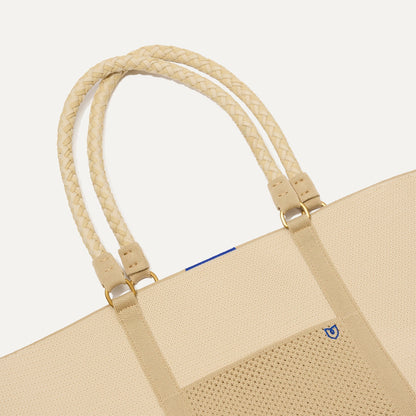 A close up of The Summer Tote in Meringue focusing on the pocket and handles.