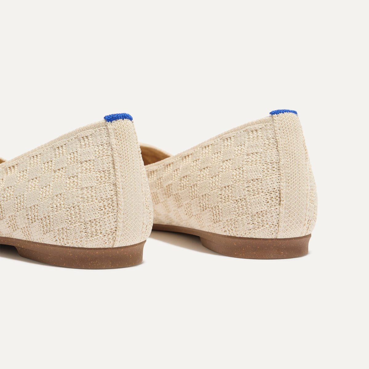 Close up of the heel of The Max Square in Conch with Rothy's signature blue halo.