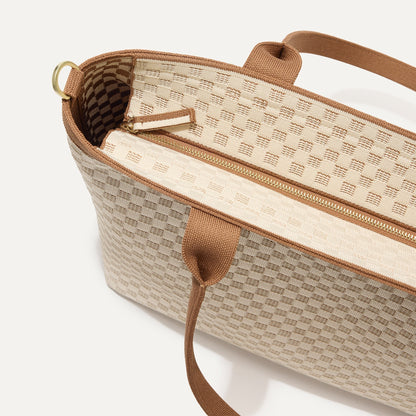 A close up of The Lightweight Zip Tote in Vanilla Wafer focusing on the zip closure and handles.