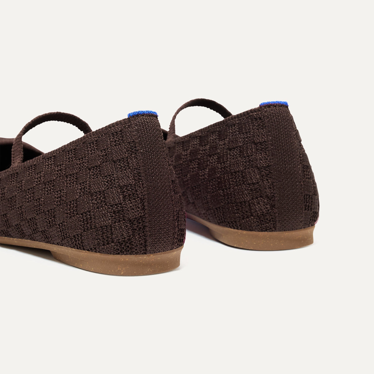 Close up of the heel of The Max Square Mary Jane in Chocolate, with Rothy's signature blue halo.
