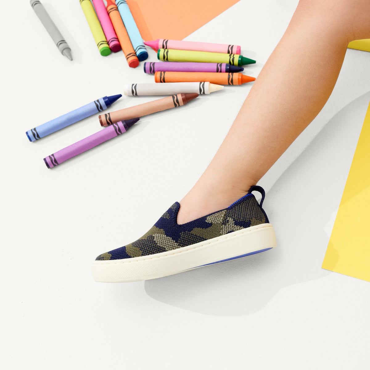 hover | Model wearing The Kids Sneaker in Spruce Camo.