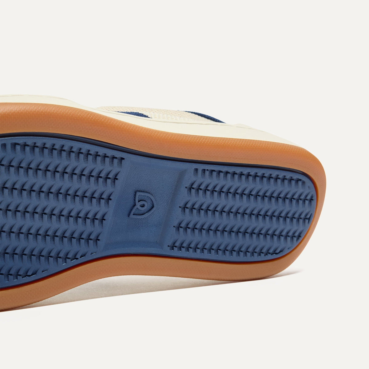 Close up of the outsoles of The Men's Court Sneaker in Freestyle.