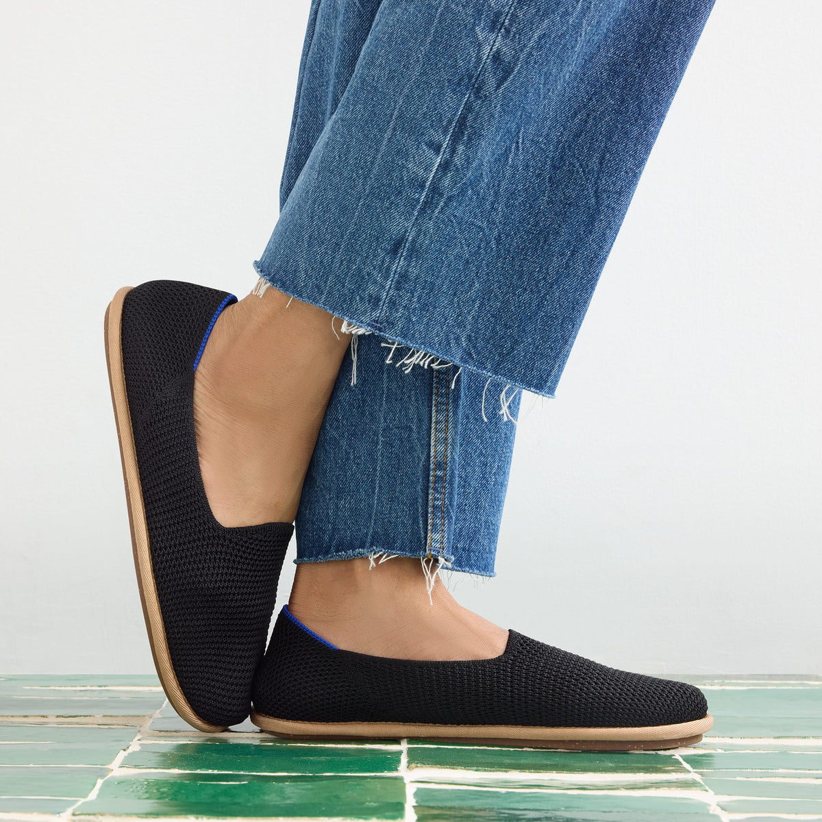 hover | Model wearing The Cruiser Loafer in Black Raffia-Knit.