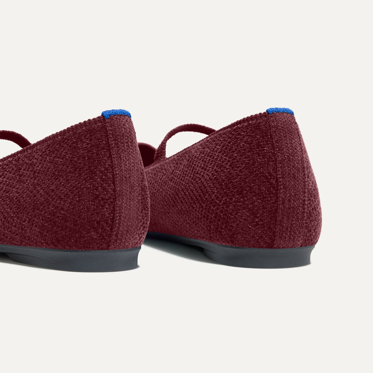 Close up of the heel of The Max Square Mary Jane in ReVelvet™ Syrah, with Rothy's signature blue halo.