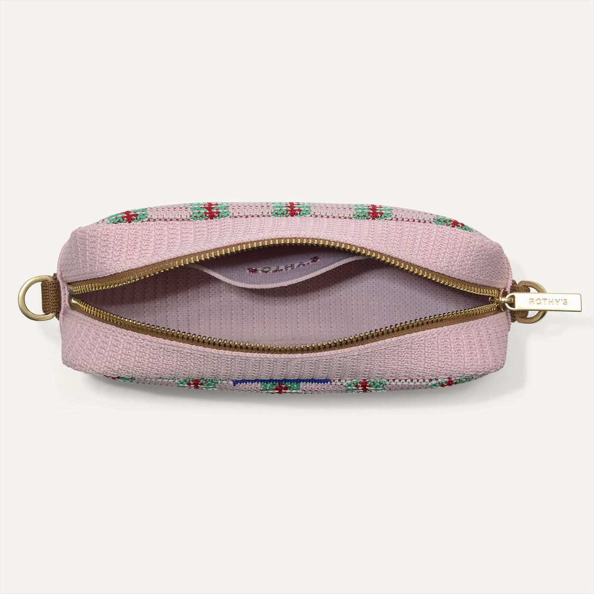 The Crossbody Camera Bag in Watermelon Market Stripe, shown from above, with the interior exposed.