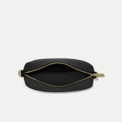 The Crossbody Camera Bag in Black Licorice Open-Knit, shown from above, with the interior exposed.