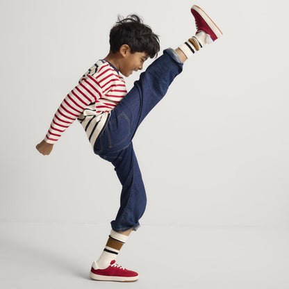 model | Alternate image of a child modeling The Kids Stretch Sneaker in Firecracker.
