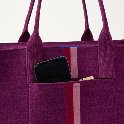 A closeup of The Classic Tote in ReVelvet Orchid, focusing on the exterior zip pocket.